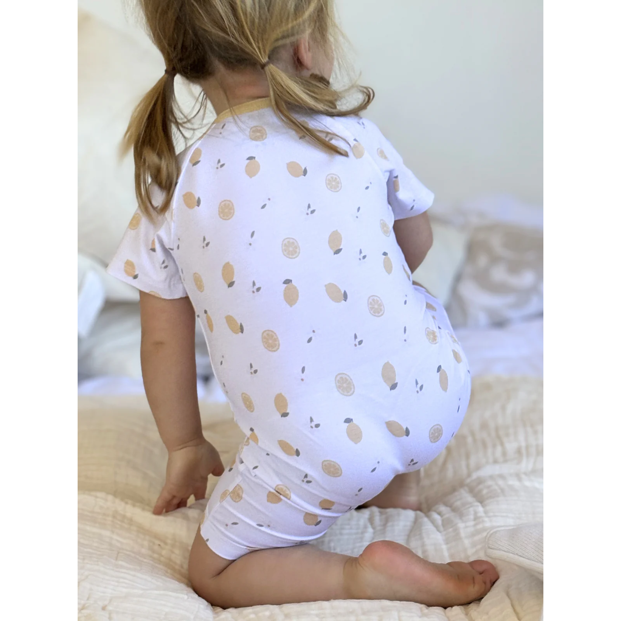 אוברול קצר עם רוכסן - צבע לבן מעוטר בלימונים